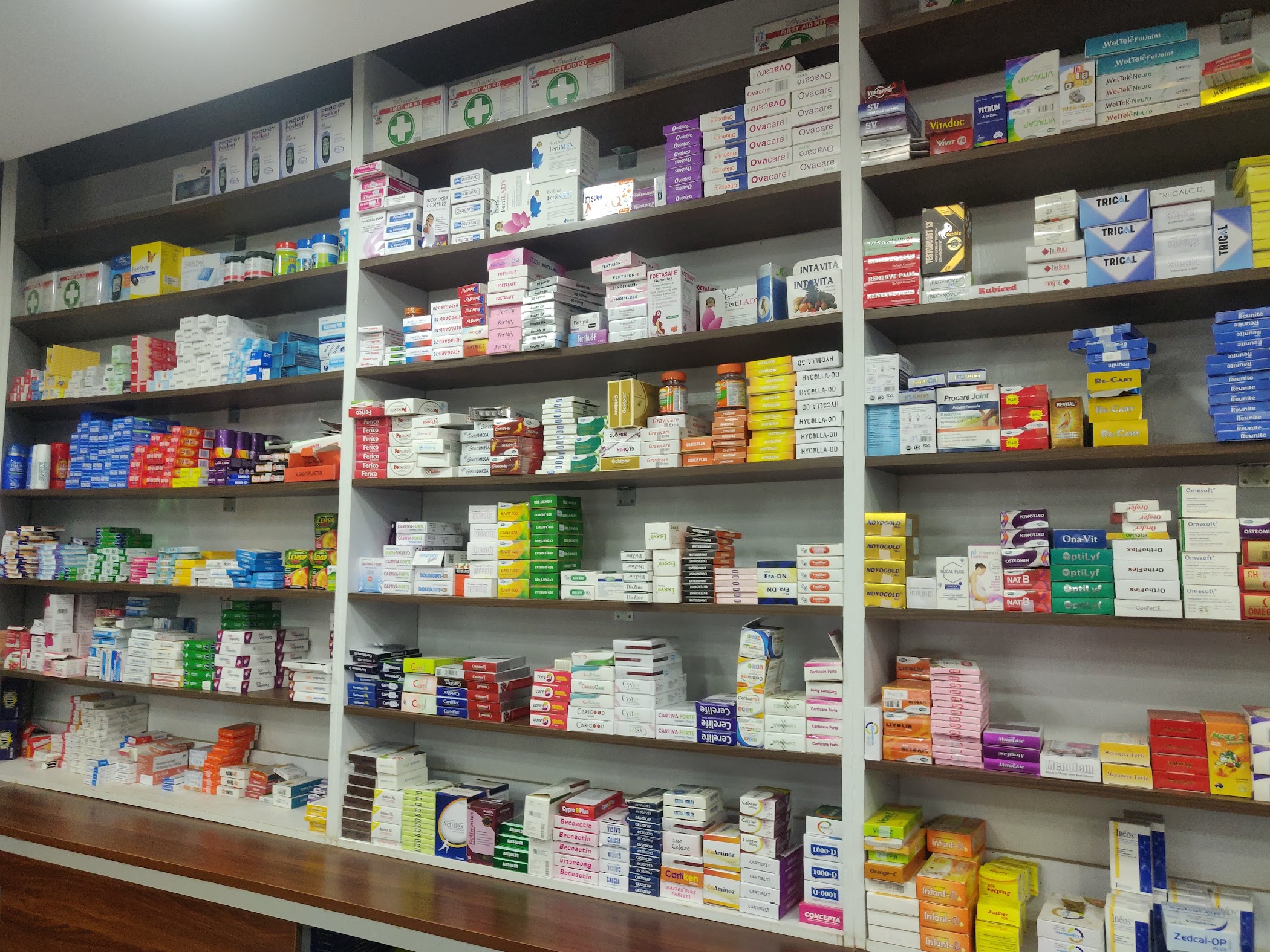 Real pharmacy shelves stocked with boxed medicines and health products